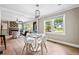 Stylish dining room with modern lighting, white chairs, hardwood floors, and a view into the living room at 1623 Athens Sw Ave, Atlanta, GA 30310
