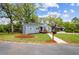 Landscaped front yard featuring manicured lawn and a mailbox near the road. The charming home has gray paint and brick at 1623 Athens Sw Ave, Atlanta, GA 30310