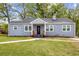 Charming one-story home with gray brick exterior, a manicured lawn, and a inviting entrance with stairs at 1623 Athens Sw Ave, Atlanta, GA 30310