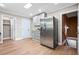 Bright kitchen showcasing stainless steel refrigerator and access to stairs and pantry at 1623 Athens Sw Ave, Atlanta, GA 30310