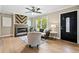 Cozy living room with hardwood floors, a stylish fireplace, comfortable seating, and natural light from the window at 1623 Athens Sw Ave, Atlanta, GA 30310