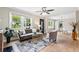Bright living room featuring stylish furnishings, a decorative rug, hardwood floors, and a view into the dining area at 1623 Athens Sw Ave, Atlanta, GA 30310