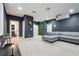 Finished basement with a projector, gray sectional sofa, and neutral carpeted flooring at 245 Fairview Cir, Roswell, GA 30076