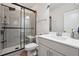 Modern bathroom features a large glass-enclosed shower with gray tile and a sleek white vanity with sink at 245 Fairview Cir, Roswell, GA 30076