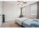 Cozy bedroom features carpeted floors, white walls, large windows, and a full-size bed at 245 Fairview Cir, Roswell, GA 30076
