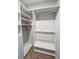 A well-organized walk-in closet with built-in shelving and rods provides ample storage space at 245 Fairview Cir, Roswell, GA 30076