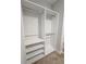 A walk-in closet featuring custom shelving and rod system maximizes space and organization at 245 Fairview Cir, Roswell, GA 30076