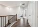 Hallway featuring wood floors and a staircase with wood and iron railing at 245 Fairview Cir, Roswell, GA 30076