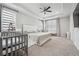 Bright main bedroom with carpet, ceiling fan, large windows, and a crib at 245 Fairview Cir, Roswell, GA 30076