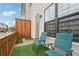 Cozy patio with synthetic grass, privacy screen and two chairs for relaxing outside at 245 Fairview Cir, Roswell, GA 30076