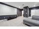 A finished theater room with dark walls, gray carpet and a projection screen provides the perfect entertainment space at 245 Fairview Cir, Roswell, GA 30076