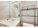 A bathroom featuring a white sink and vanity and a metal storage unit above the toilet at 2758 Snapfinger Mnr, Decatur, GA 30035