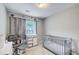 Bright bedroom featuring a crib, a changing table and chair, and cute space themed decorations at 2758 Snapfinger Mnr, Decatur, GA 30035