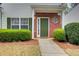 Inviting entryway with lush green bushes, brick accents, a round window, and a well-lit path at 2758 Snapfinger Mnr, Decatur, GA 30035