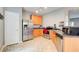 Galley kitchen with stainless steel appliances, wooden cabinets and neutral tone flooring at 2758 Snapfinger Mnr, Decatur, GA 30035