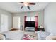 Bright living room with a large TV, a cozy gray couch, and natural light from the front window at 2758 Snapfinger Mnr, Decatur, GA 30035