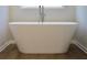 Close up on a freestanding tub in a bright bathroom with wood-look tile at 684 Egrets Landing #62, Covington, GA 30014
