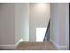 An upward view of a carpeted staircase with a railing, next to a white wall at 684 Egrets Landing #62, Covington, GA 30014
