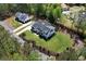 Beautiful home with a manicured lawn, lush landscaping, an estate fence, and a long driveway at 120 Farm Gate Dr, Woodstock, GA 30188