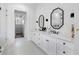 Bright bathroom featuring double vanity, modern mirrors, and a glass-enclosed shower at 120 Farm Gate Dr, Woodstock, GA 30188