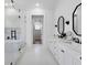 Bright bathroom featuring double vanity, modern mirrors, and a glass-enclosed shower and tub at 120 Farm Gate Dr, Woodstock, GA 30188