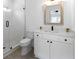 Bathroom with a shower, white vanity, and wooden framed mirror at 120 Farm Gate Dr, Woodstock, GA 30188