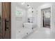 Elegant bathroom features a soaking tub, glass enclosed shower, and a wooden barn door at 120 Farm Gate Dr, Woodstock, GA 30188