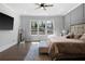 Large bedroom with hardwood floors, grid accent wall, and natural light from many windows at 120 Farm Gate Dr, Woodstock, GA 30188