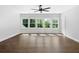 Bright bedroom features hardwood floors, white walls, large windows and modern ceiling fan at 120 Farm Gate Dr, Woodstock, GA 30188