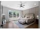Large bedroom with hardwood floors, grid accent wall, and natural light from many windows at 120 Farm Gate Dr, Woodstock, GA 30188