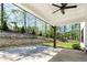 Covered patio featuring an outdoor ceiling fan, wood columns, and a view of the landscaped backyard at 120 Farm Gate Dr, Woodstock, GA 30188