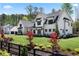 Beautiful home with an attached garage, a large front lawn, and mature landscaping at 120 Farm Gate Dr, Woodstock, GA 30188