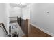 Upstairs hallway with hardwood floors, wood and metal railing, and view to downstairs at 120 Farm Gate Dr, Woodstock, GA 30188
