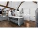 Open kitchen features a large island, pendant lighting, modern appliances, and a vaulted ceiling at 120 Farm Gate Dr, Woodstock, GA 30188
