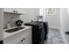 Laundry room featuring modern black appliances and stylish countertops at 120 Farm Gate Dr, Woodstock, GA 30188