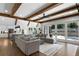 Comfortable living area flowing to the kitchen features hardwood floors, wooden beams, and sliding glass doors at 120 Farm Gate Dr, Woodstock, GA 30188