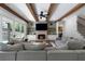 Comfortable living room with a fireplace, wooden beams, large windows, and an open floor plan at 120 Farm Gate Dr, Woodstock, GA 30188