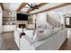 Inviting living room with hardwood floors, a brick fireplace, wooden beams, and a staircase at 120 Farm Gate Dr, Woodstock, GA 30188