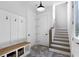 Mudroom featuring built in bench, coat hooks, and wood-trimmed stairs at 120 Farm Gate Dr, Woodstock, GA 30188