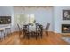 Dining area adjacent to the kitchen and fireplace, features hardwood floors, and natural light at 2109 Defoors Ferry Nw Rd # D, Atlanta, GA 30318