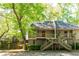 Charming townhouse featuring a wooden deck entrance and lush green surroundings at 2109 Defoors Ferry Nw Rd # D, Atlanta, GA 30318