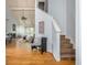 Bright foyer with hardwood floors, high ceilings, and a staircase, leading into an open-concept living and dining area at 2109 Defoors Ferry Nw Rd # D, Atlanta, GA 30318