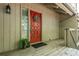 Close-up of a vibrant red front door with decorative details, enhancing the curb appeal of this inviting townhome at 2109 Defoors Ferry Nw Rd # D, Atlanta, GA 30318