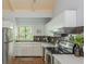 Bright kitchen featuring stainless steel refrigerator, white cabinets, quartz countertops, and decorative tile backsplash at 2109 Defoors Ferry Nw Rd # D, Atlanta, GA 30318