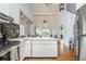 Open concept with kitchen and dining area visible, white cabinets, and stainless steel appliances at 2109 Defoors Ferry Nw Rd # D, Atlanta, GA 30318