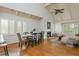 Open concept living area and dining area with fireplace, hardwood floors, and natural light at 2109 Defoors Ferry Nw Rd # D, Atlanta, GA 30318