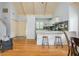 Open concept living area with vaulted ceilings, hardwood floors, and a view into the kitchen at 2109 Defoors Ferry Nw Rd # D, Atlanta, GA 30318