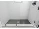 Modern shower features white tile walls and a black hexagon tile floor at 2109 Defoors Ferry Nw Rd # D, Atlanta, GA 30318