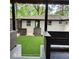 Inviting backyard featuring artificial grass, dark stained wood fence and columns, and a white painted brick house at 3572 Adkins Nw Rd, Atlanta, GA 30331