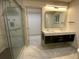 Modern bathroom featuring double sink vanity with marble countertop, glass shower, and gray tile flooring at 3572 Adkins Nw Rd, Atlanta, GA 30331